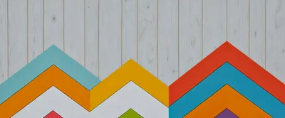 Colorful Chevron Pattern On White Wooden Background