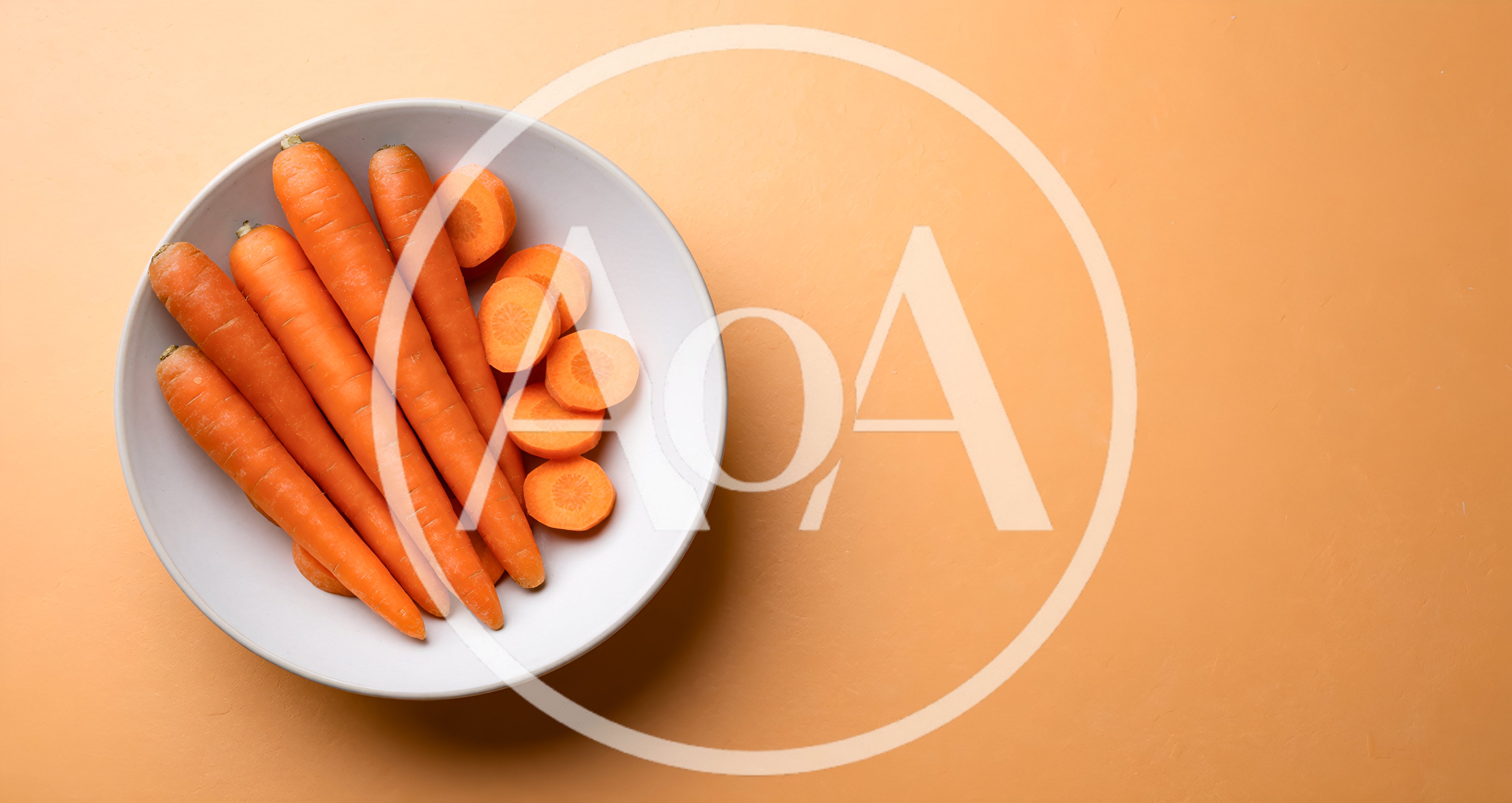 Fresh Whole And Sliced Carrots In A White Bowl