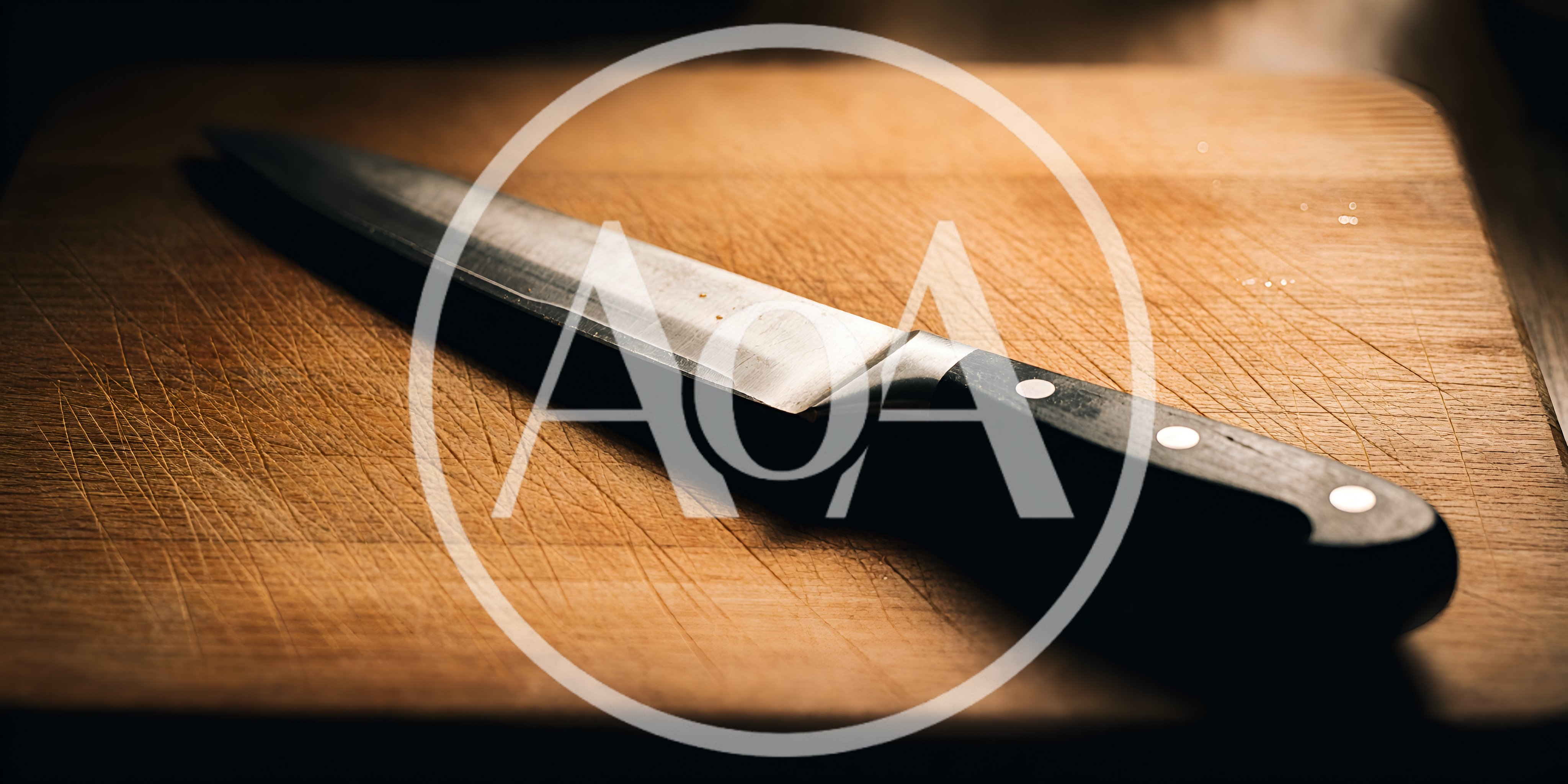Chef Knife Resting On A Wooden Cutting Board