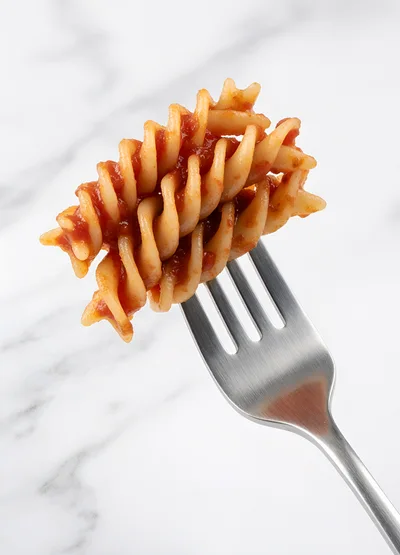 Fusilli Pasta With Tomato Sauce On A Fork