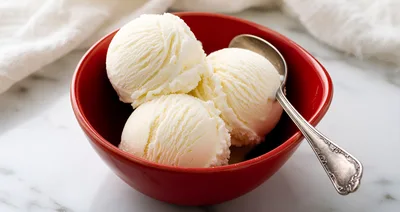 Three Scoops Of Vanilla Ice Cream In A Red Bowl