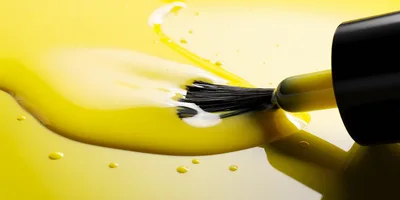 Yellow Nail Polish Brush With Liquid Spill