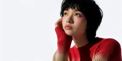 Young Woman With Artistic Makeup Posing In Red Sweater