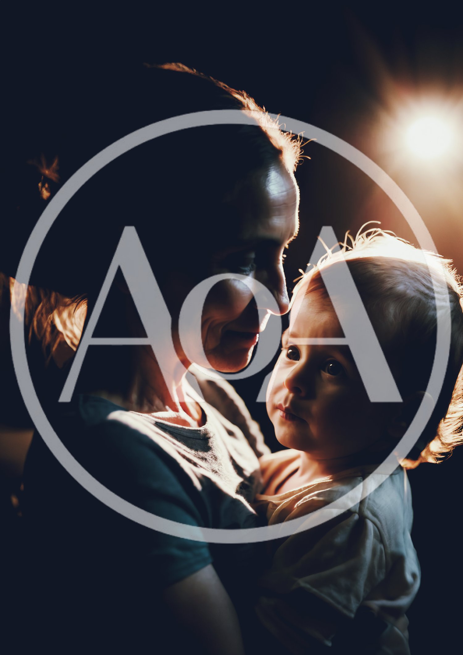 Mother Holding Her Baby in Dramatic Backlit Portrait