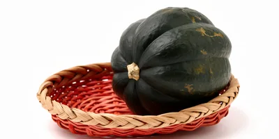 Acorn Squash Resting In A Woven Basket