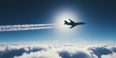 Private Jet Flying Above Clouds With Contrails