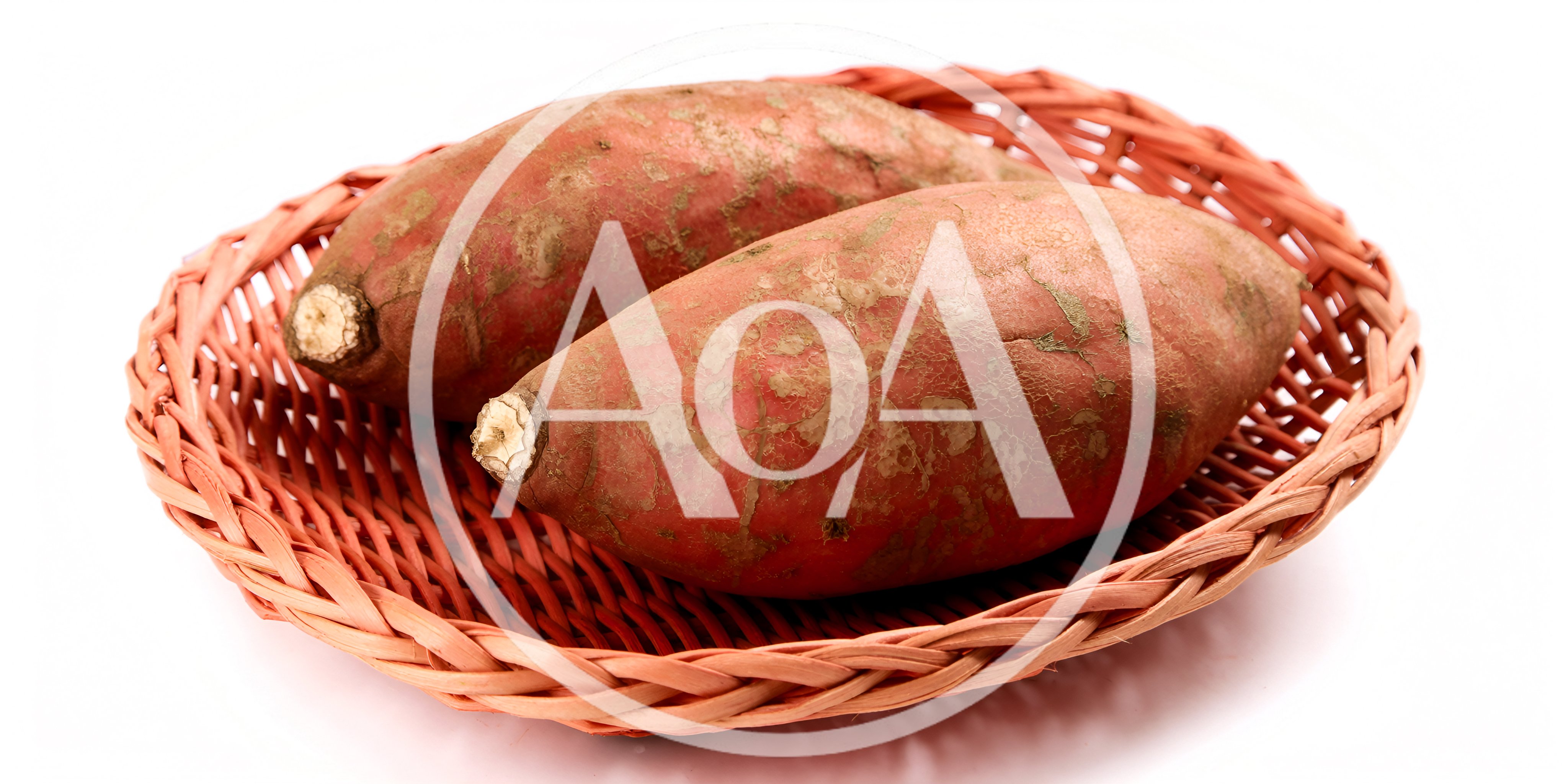Two Raw Sweet Potatoes In A Woven Basket