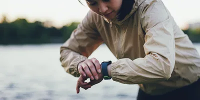 Young Woman Checking Her Fitness Tracker Outdoors