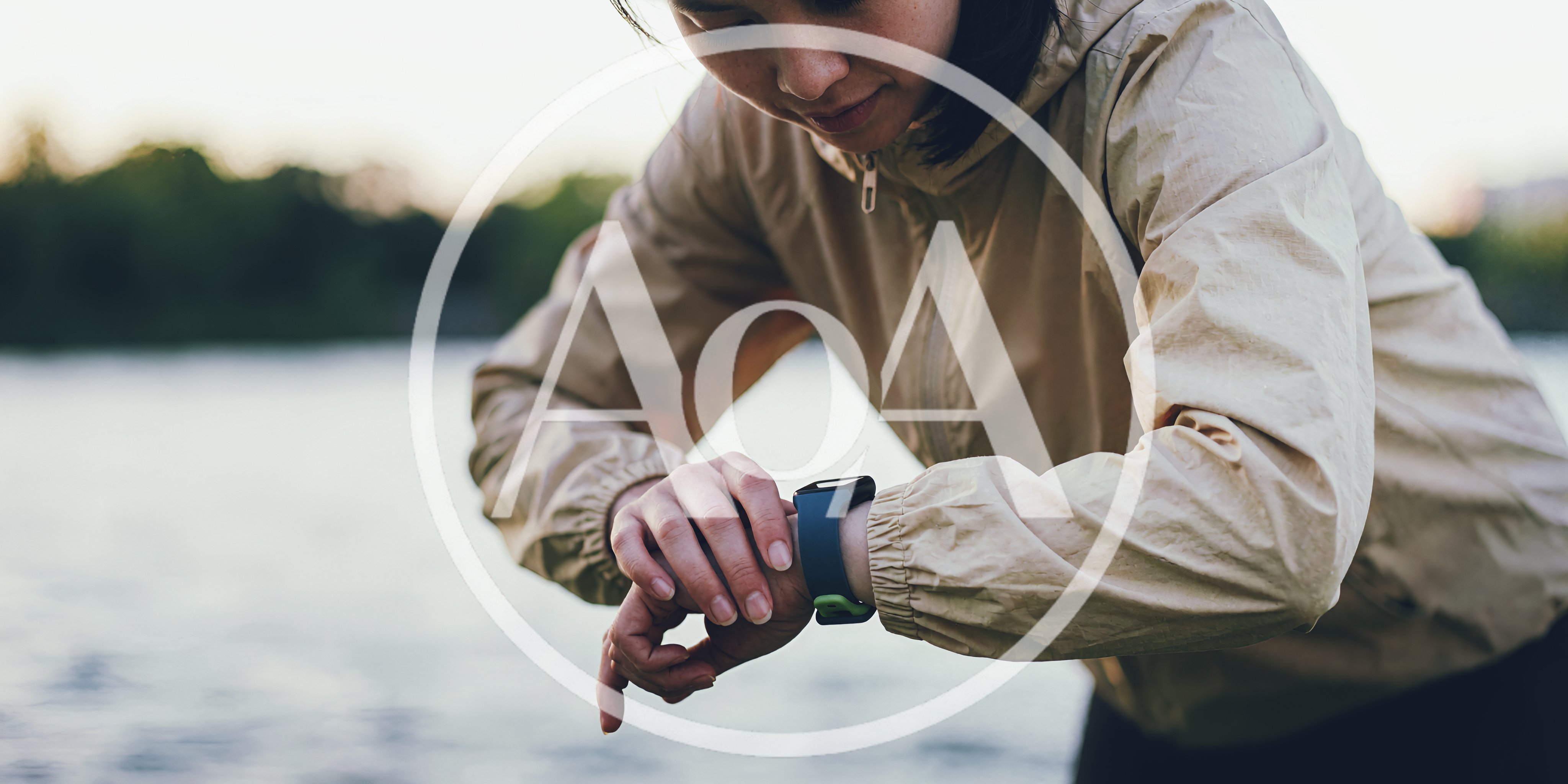 Young Woman Checking Her Fitness Tracker Outdoors