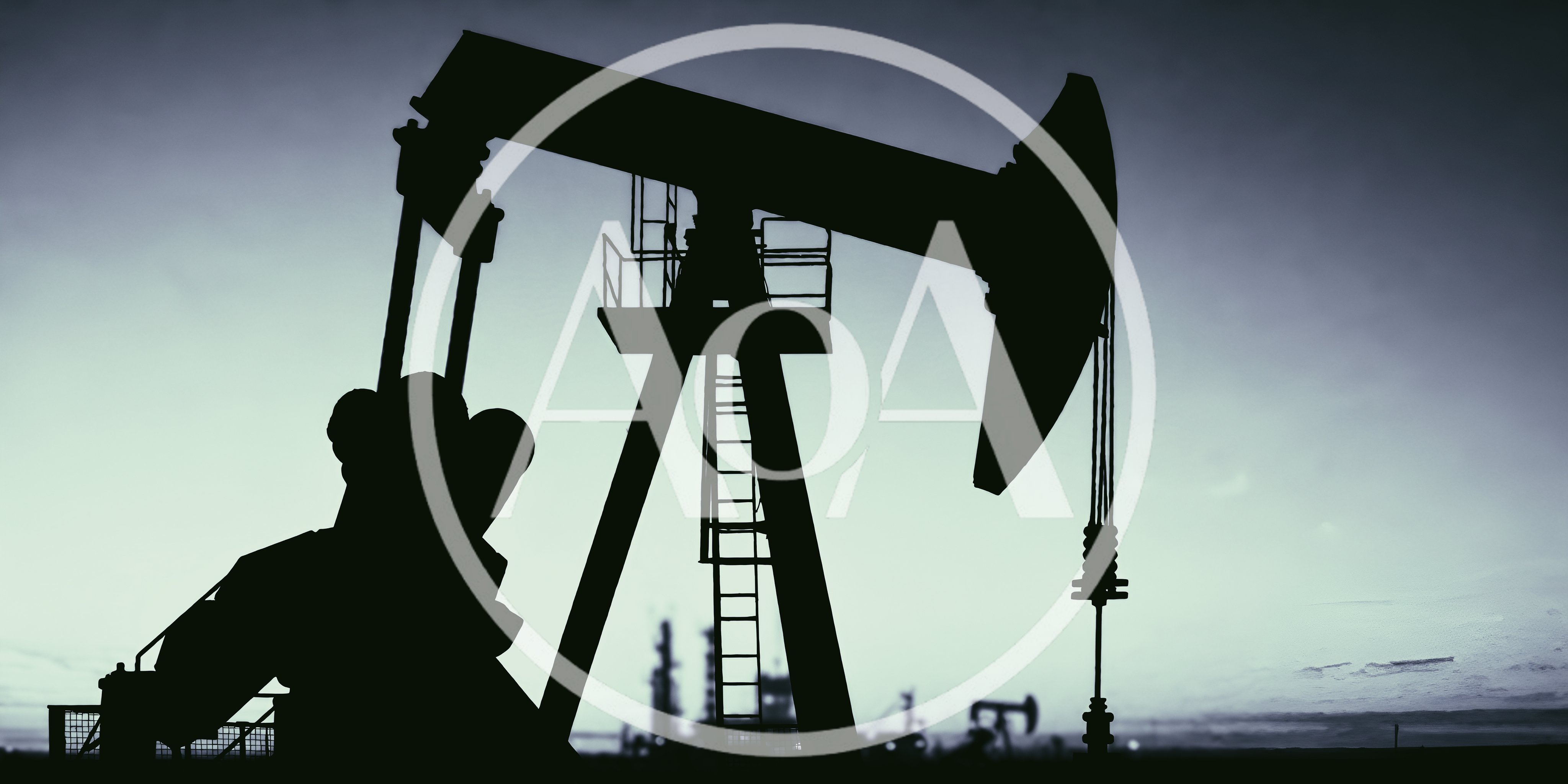 Oil Pump Jack Silhouette Against A Twilight Sky