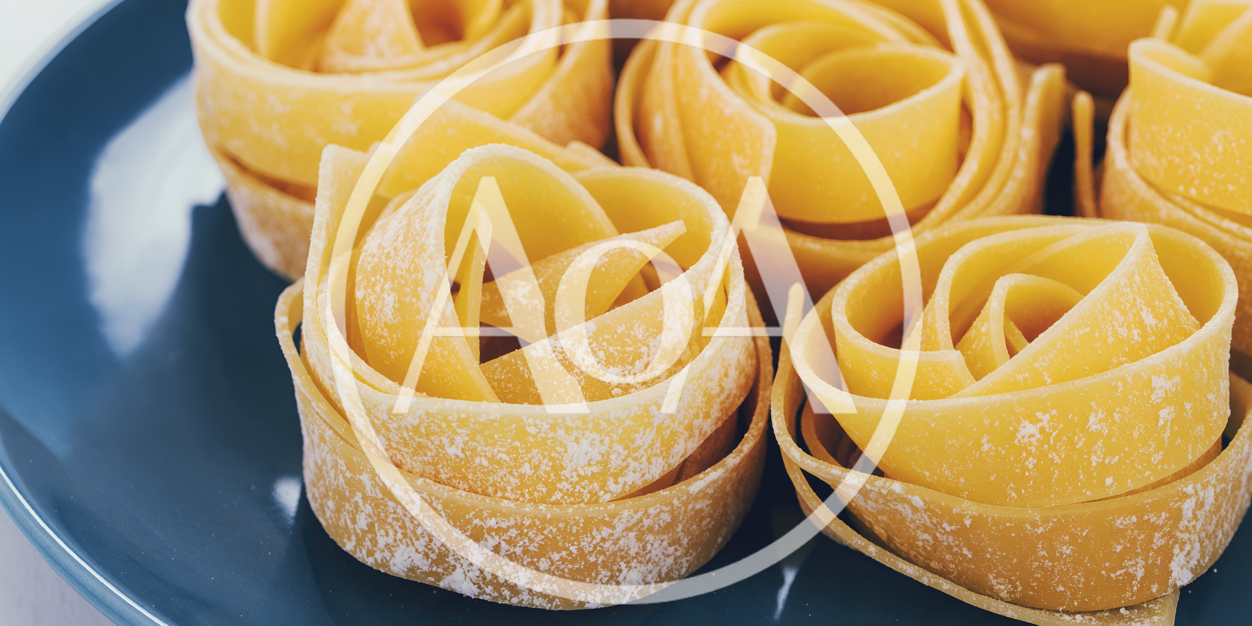 Raw Pappardelle Pasta Nests On A Blue Plate