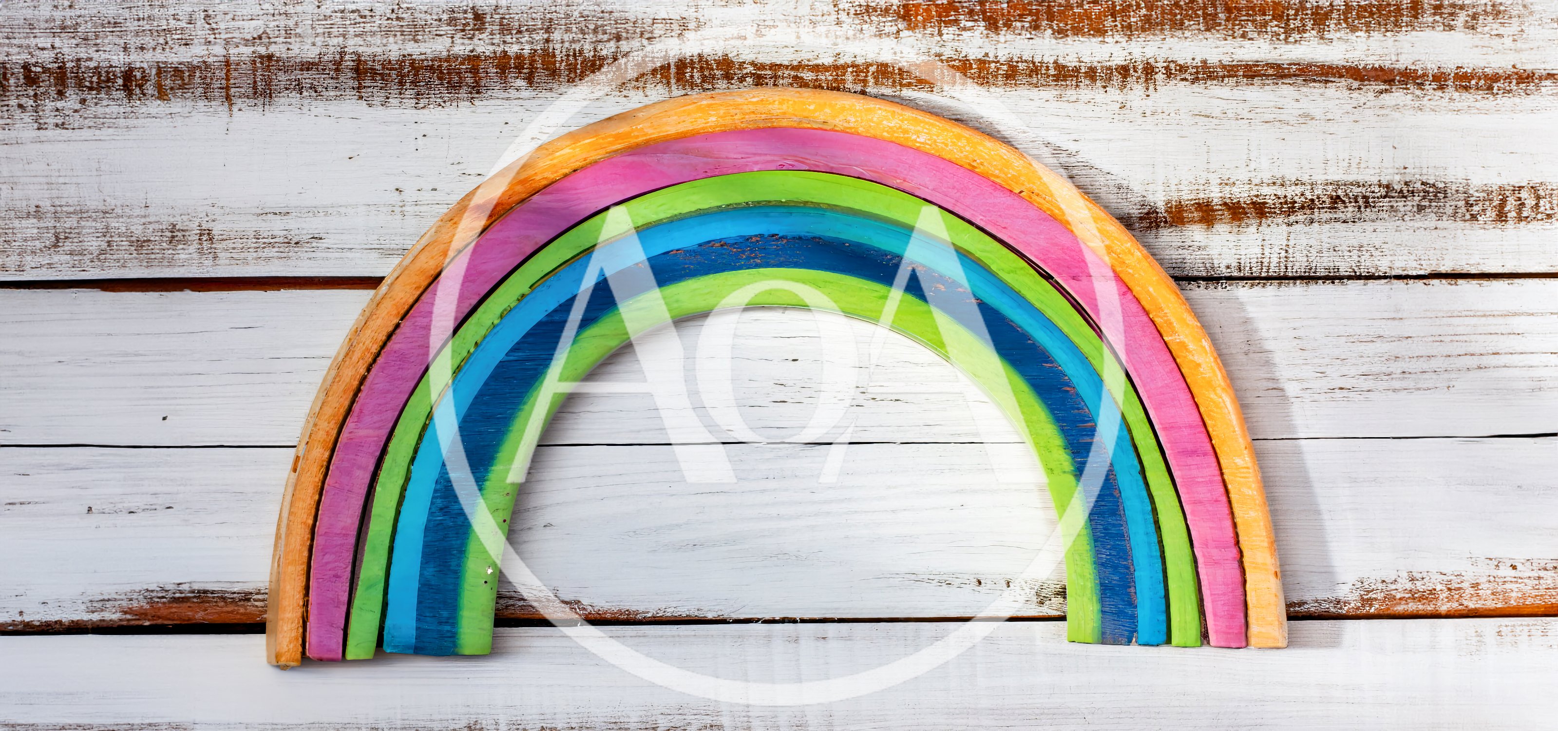 Wooden Rainbow Toy On White Distressed Wood Background