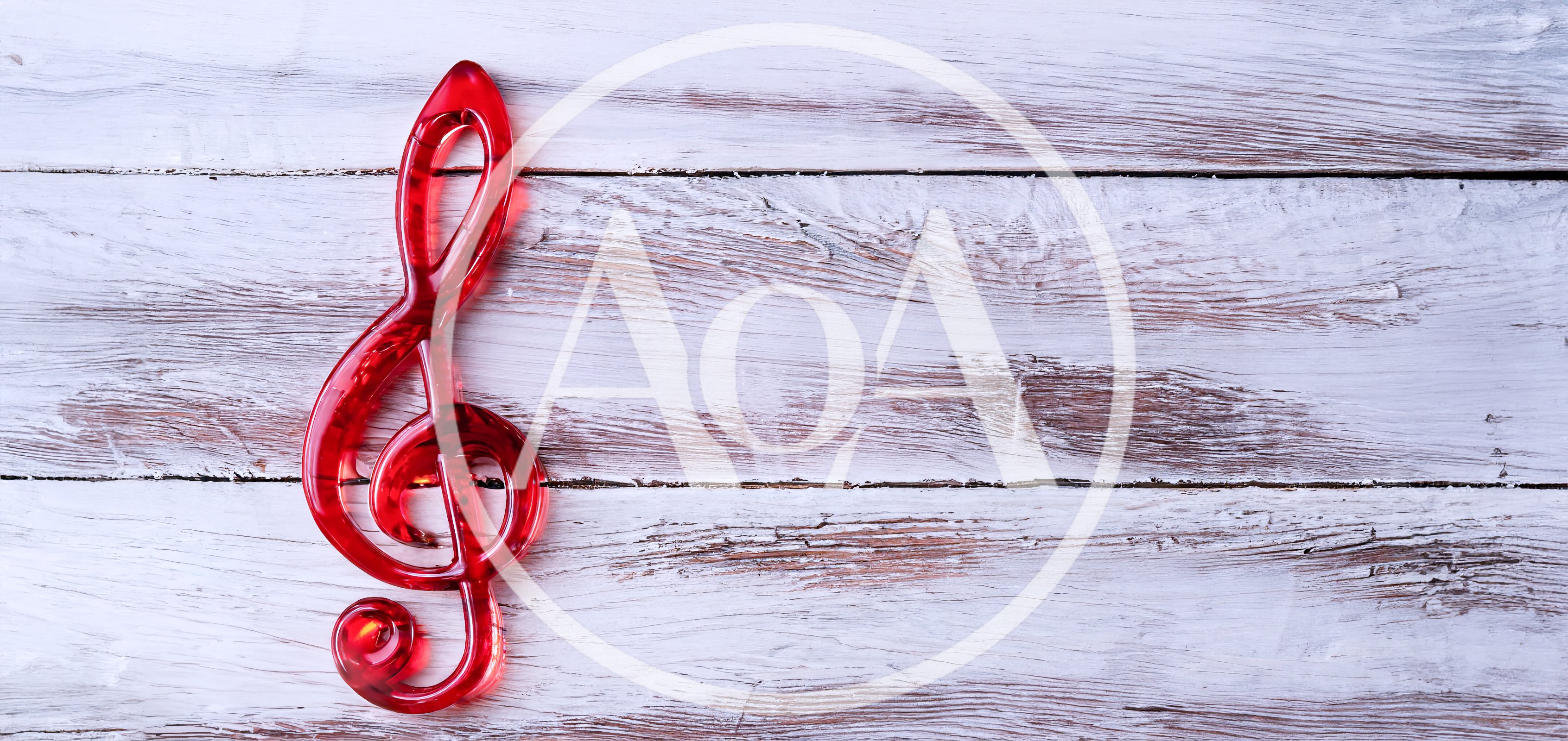 Red Treble Clef Symbol on White Wooden Background