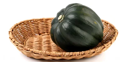 Dark Green Acorn Squash in a Woven Basket