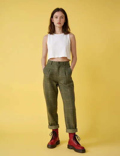 Young Woman Posing in Plaid Trousers and Red Boots