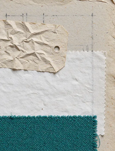 Textile Swatches and Paper Tag on Textured Background