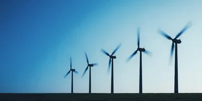 Five Wind Turbines Rotating In A Field