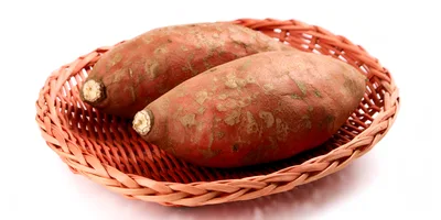 Two Raw Sweet Potatoes In A Woven Basket
