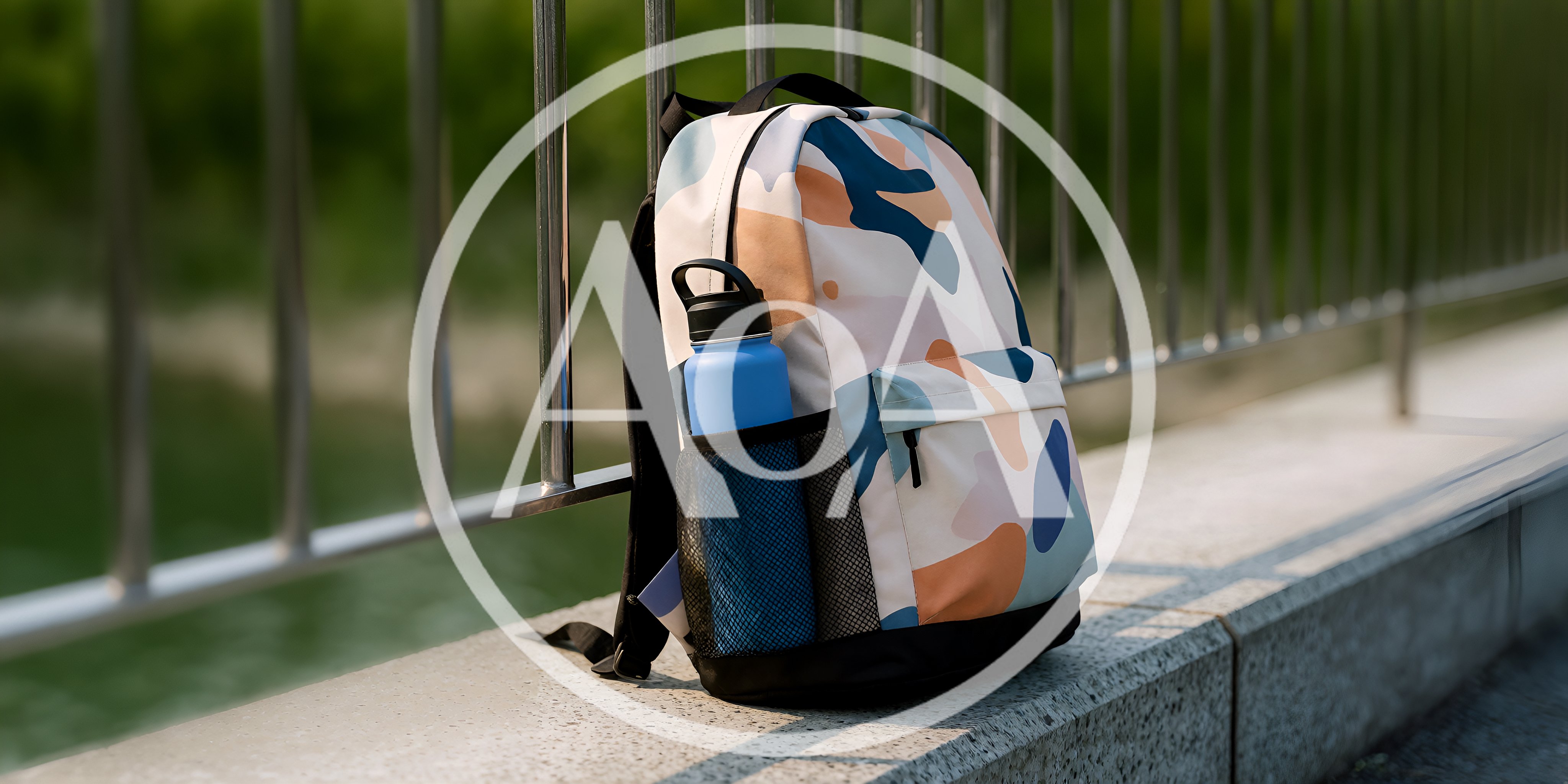 Patterned Backpack With Water Bottle On Concrete Ledge