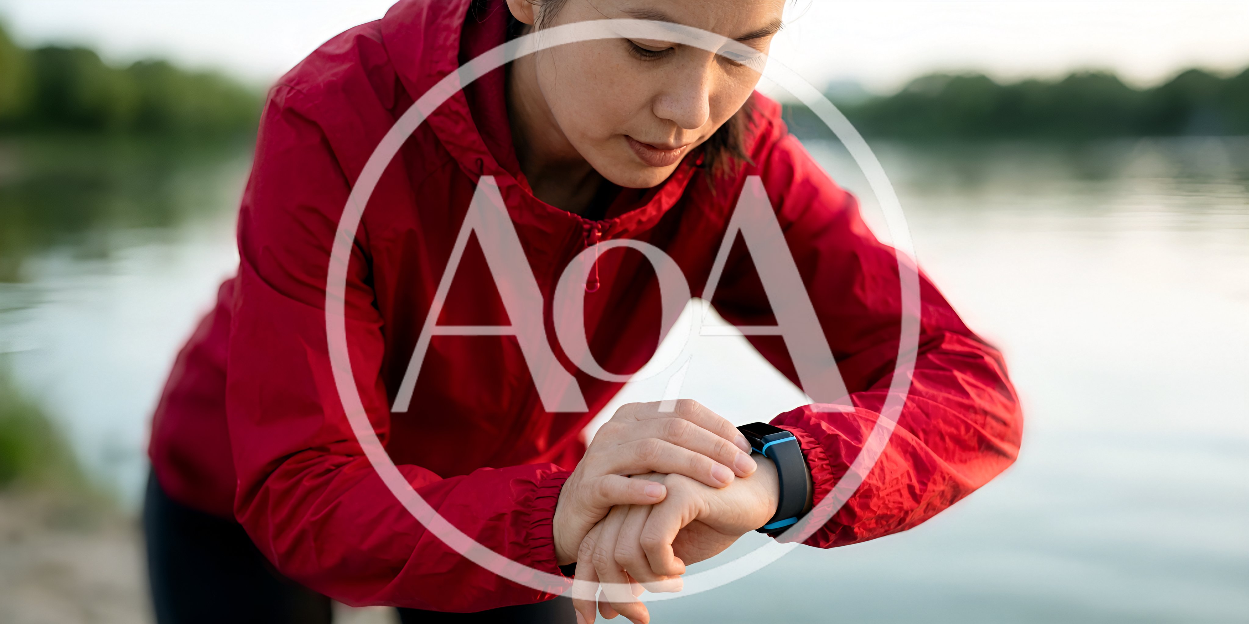 Asian Woman Checking Fitness Tracker During Outdoor Run
