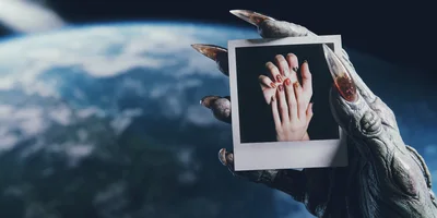 Alien Hand Holding A Polaroid Of Manicured Hands