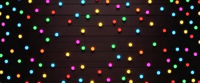 Colorful Glowing Christmas Lights On Dark Wooden Background