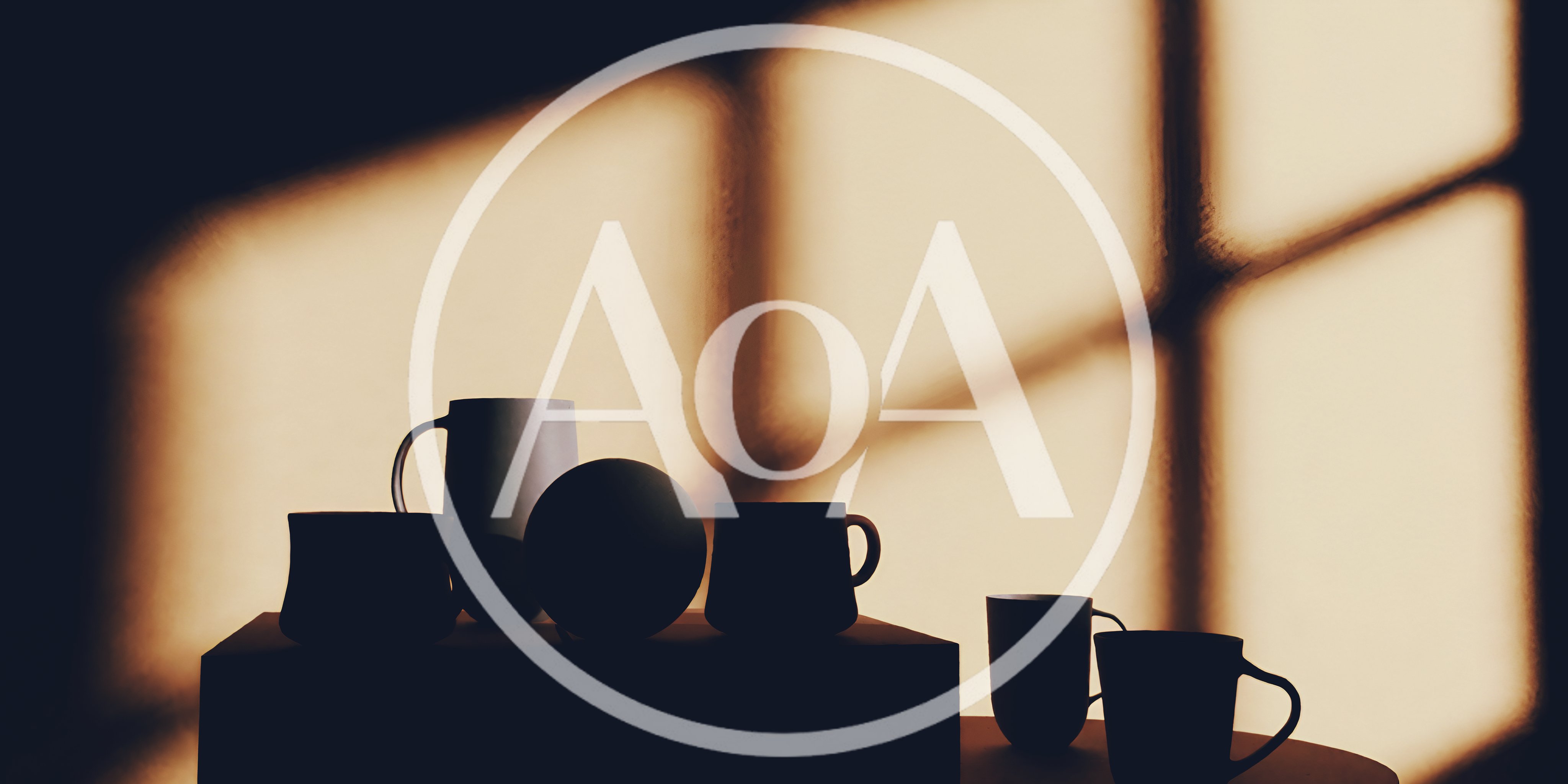 Silhouetted Mugs And Sphere On A Table