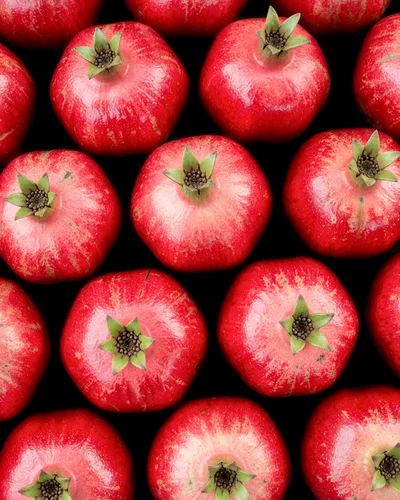 Fresh Ripe Pomegranates Arranged In A Pattern