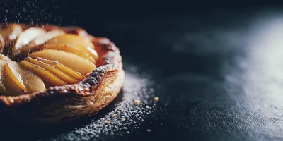 Powdered Sugar Sprinkled Over A Fresh Pear Tart