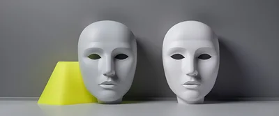 Two White Human Masks Against A Grey Wall