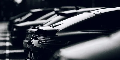 Rear View Of Luxury Sports Cars Parked In Line