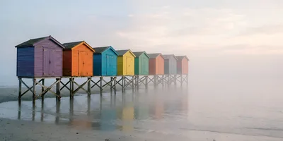Colorful Beach Huts On Stilts In Morning Fog