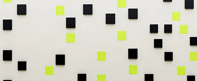 Black Squares And Yellow Sticky Notes On White Wall