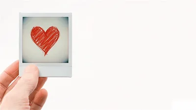 Hand Holding A Polaroid Photo With A Red Heart