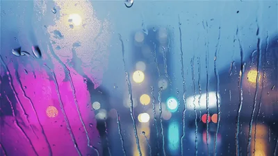 Raindrops Running Down A Car Window At Night