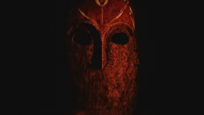 Ancient Tribal Mask Floating In Dark Chamber