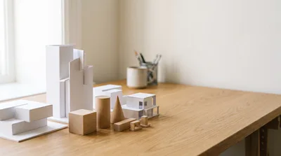 Architectural Models And Wooden Shapes On A Desk