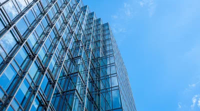 Modern Glass Skyscraper Facade Against Blue Sky