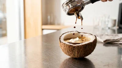Espresso Pouring Into A Coconut Shell Bowl