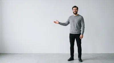 Man In Grey Sweater Gesturing To Empty Space