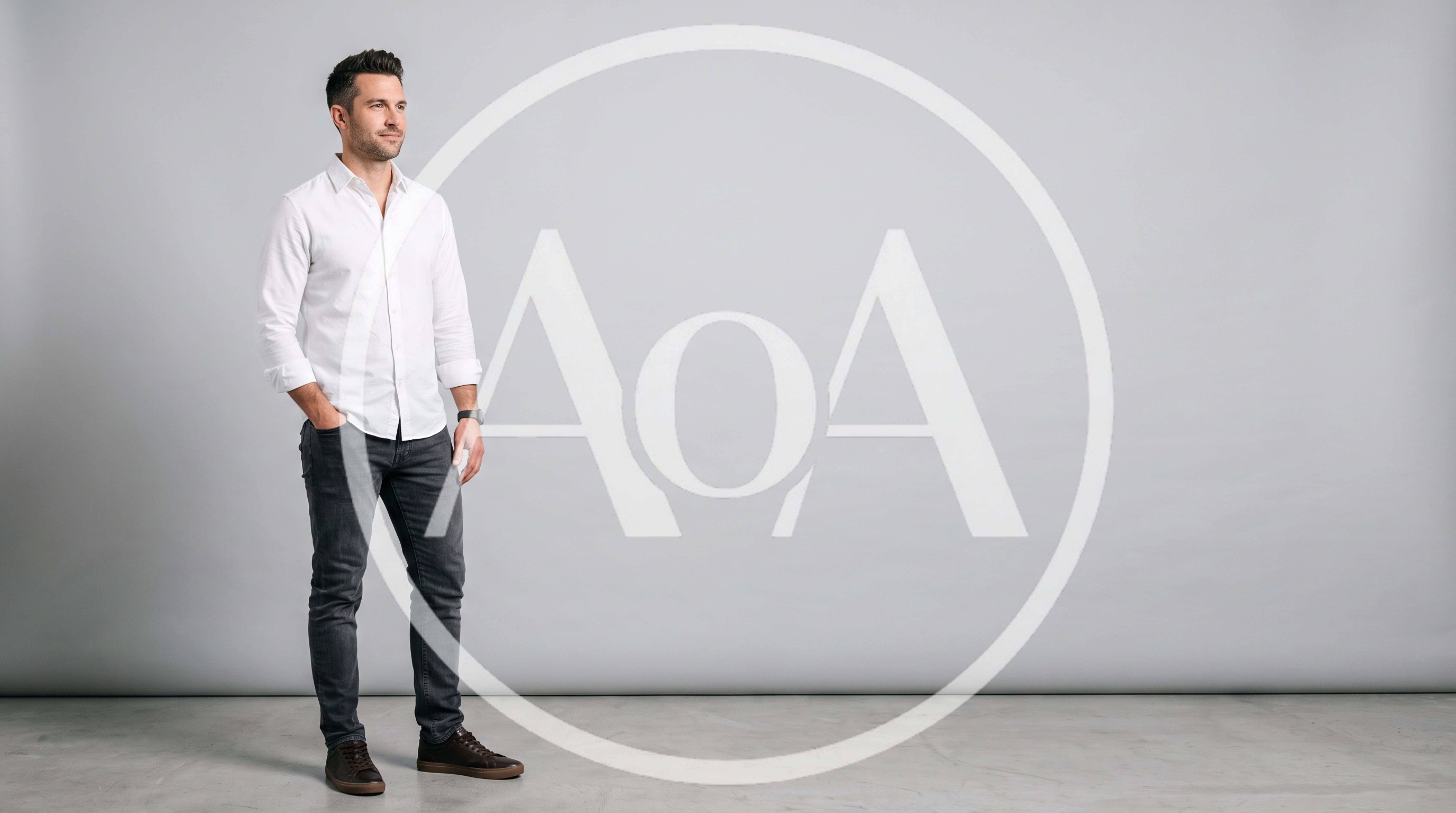 Man Standing In White Shirt And Jeans