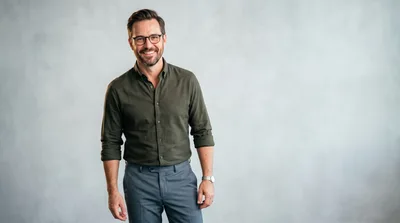 Smiling Professional Man Standing Against Grey Background