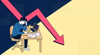Stressed Businessman Looking At Declining Financial Chart