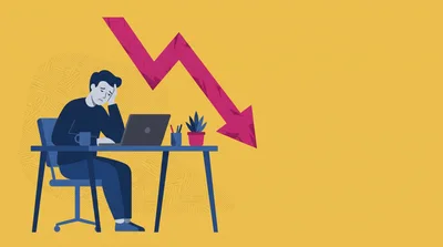 Stressed Businessman Working On Laptop With Declining Chart