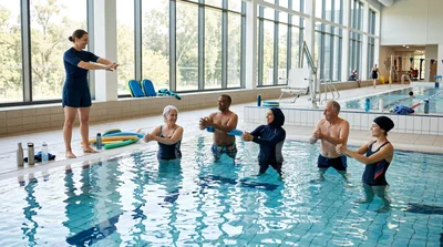 Diverse Group Participating In Water Aerobics Class