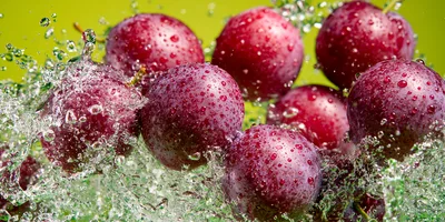 Fresh Plums Splashing In Water