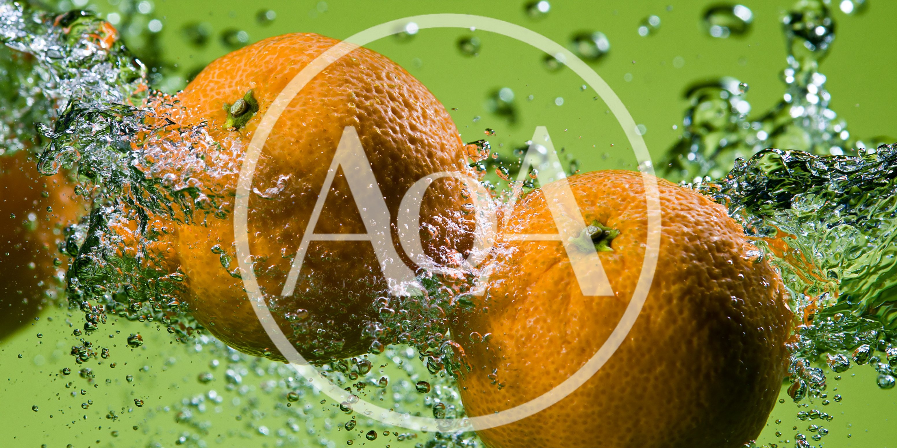 Two Fresh Oranges Splashing Into Water