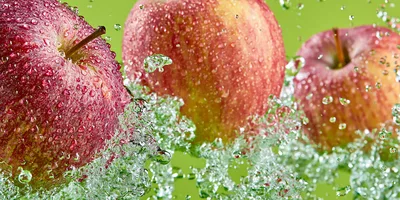 Three Fresh Red Apples Splashing In Water