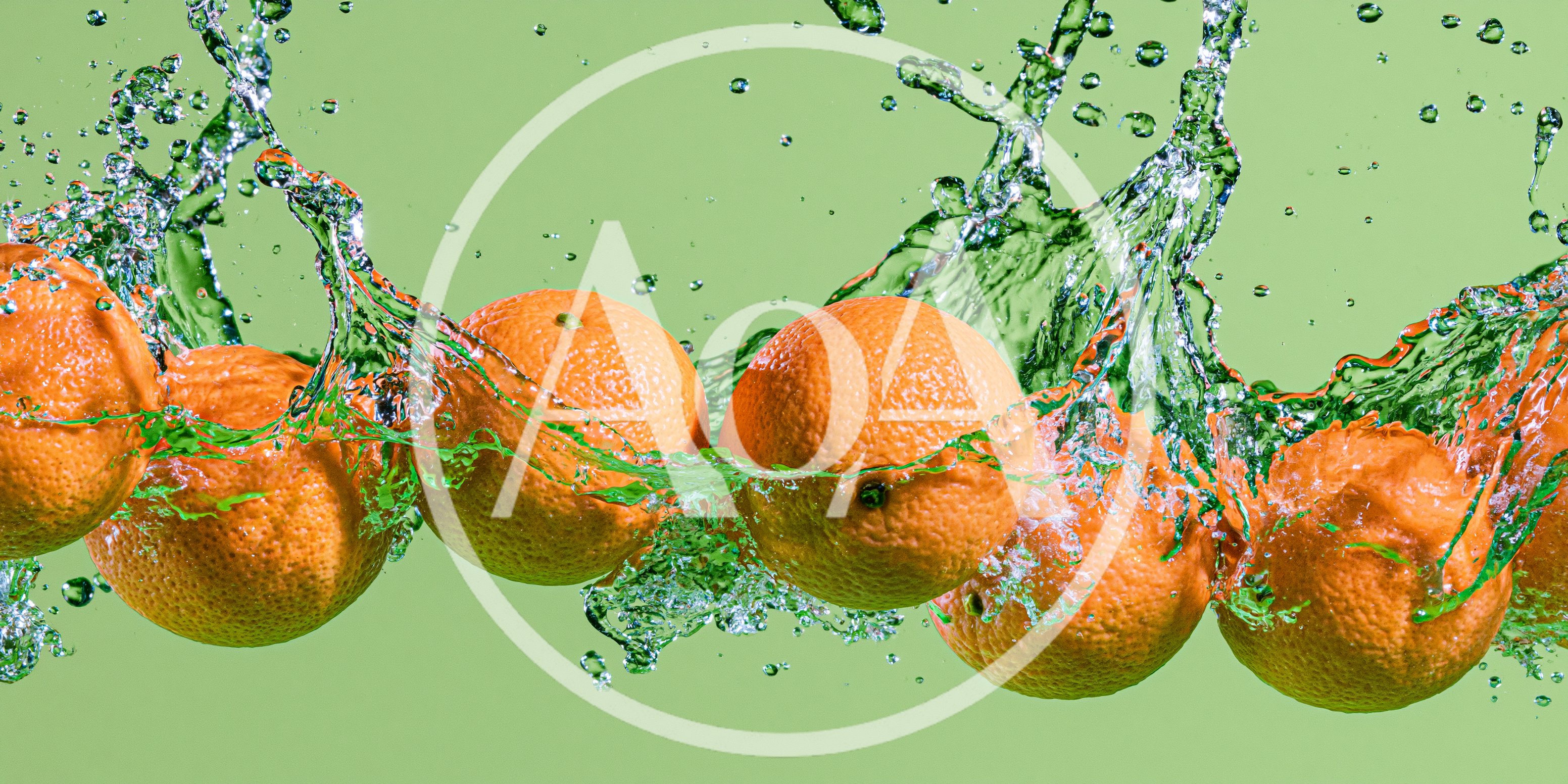 Fresh Oranges Splashing In Water Against Green Background
