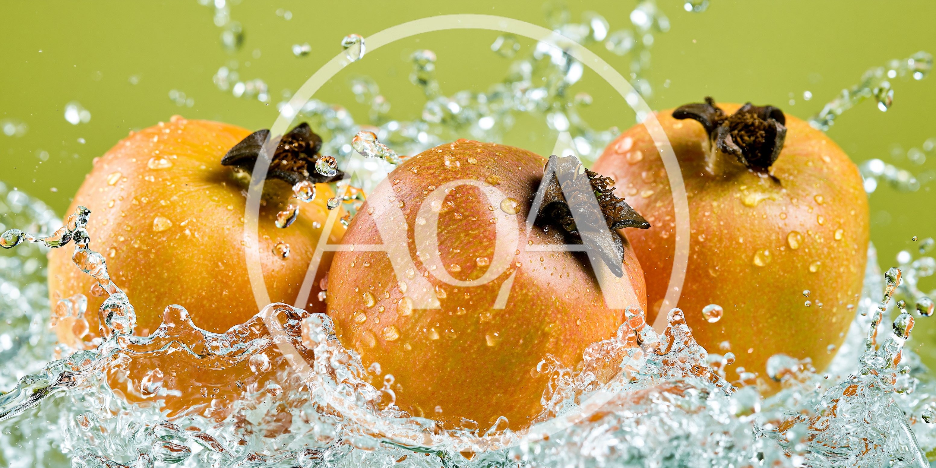 Three Fresh Pomegranates Splashing In Clear Water
